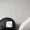 Amsterdam Hexagon Matt Grey Porcelain Wall and Floor Tile on Bathroom Floor with Matt Black Table used to hold bath towels