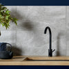 Ark Slate Cloud Grey Stone Effect 30x60cm Porcelain Wall and Floor Tile in Kitchen Close up, black tap