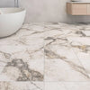 White and Grey Marble-patterned tiles in a bathroom setting with a white bathtub and wooden cabinet.