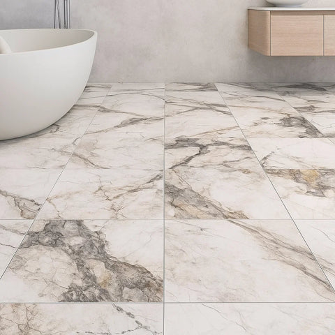 White and Grey Marble-patterned tiles in a bathroom setting with a white bathtub and wooden cabinet.