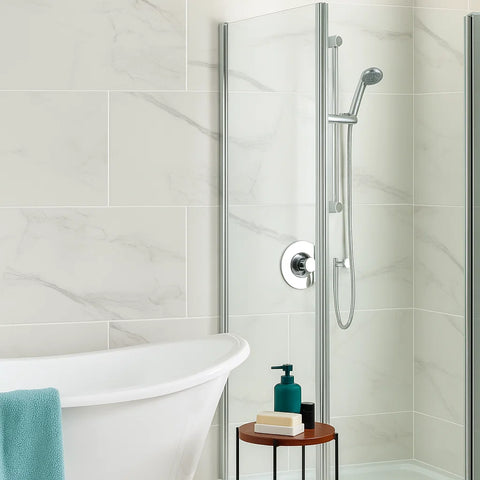 Modern Bathroom with Soft White Carrara Marble Effect Porcelain Tiles on Wall, Freestanding Bathtub next to Silver Shower Enclosure