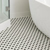 Black and white hexagon mosaic tiled floor in a bathroom setting