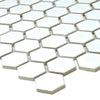 Close-up of hexagonal white tiles with grey grout on a white background