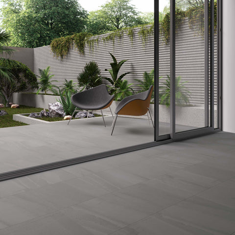 Terra Deep Grey Stone Effect Porcelain Indoor and Outdoor 600x600mm Floor Tile in Kitchen transitioning to garden patio