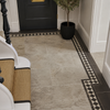 Chequered Mosaic Border Tile in white and black used as a border around light grey stone effect in a contempory town house 