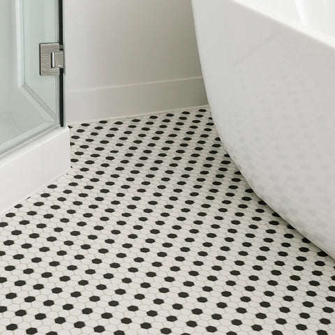 Black and white hexagon mosaic tiled floor in a bathroom setting