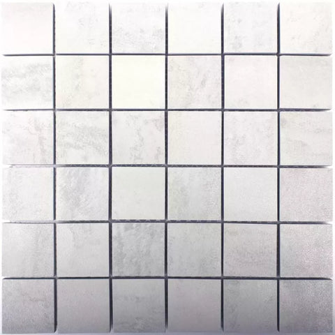 A square mosaic tile sheet featuring a grid of small, light gray to off-white marble-look tiles with dark grout lines.