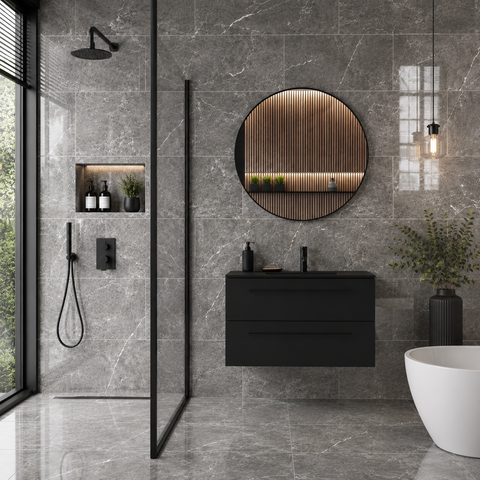 Modern bathroom with grey marble effect tiles, black vanity, and round mirror.