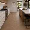 Modern kitchen with wooden floor, white cabinets, and a dining area.