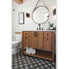 Bathroom with wooden vanity, round mirror, and white tiles.