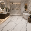 Modern bathroom with white and dark black veined marble tiles, a freestanding bathtub, and a shower area.