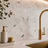 Modern kitchen sink area with gold faucet, hexagonal marble tiles, and decorative elements.