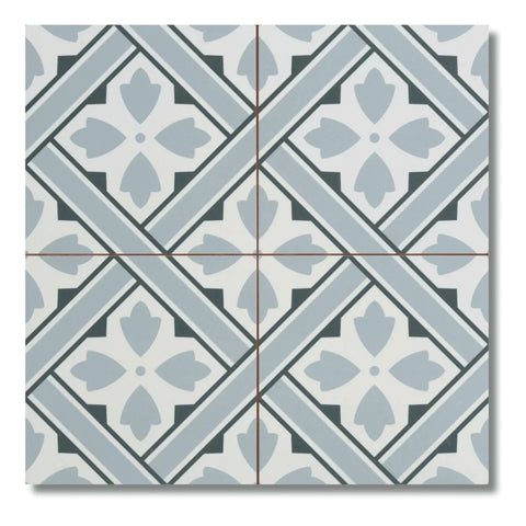 A square decorative tile with a geometric Mr Jones pattern in light blue, gray, and off-white, featuring a central floral motif and diagonal striped bands.