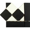 Black and white geometric mosaic wall tile sample with diamond and triangular shapes on a plain white background.