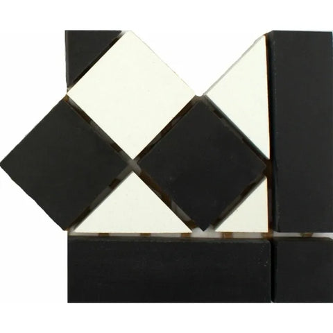 Black and white geometric mosaic wall tile sample with diamond and triangular shapes on a plain white background.