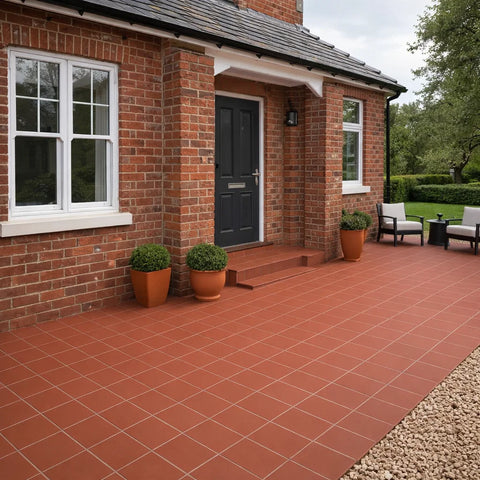 Brick house with a quarry tiled patio area and potted plants