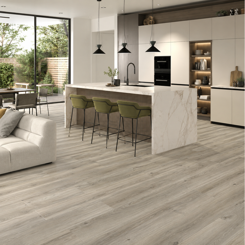 Light grey wood-look floor tiles in a modern kitchen and living room setting, showing a clean, contemporary interior design.
