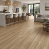 Light oak wood plank flooring shown in a modern, bright open-plan living space with a kitchen island, bar stools, sofa, and dining area.